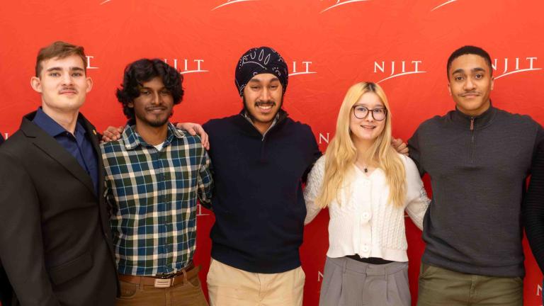 Computing students infront of a NJIT backdrop 
